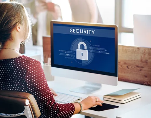 Girl using a desktop and a security logo in appearing on the laptop screen