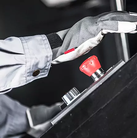 person pressing a red emergency button