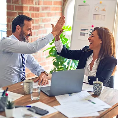 two employees giving high five to each other