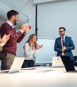 a group of employees celebrating and clapping